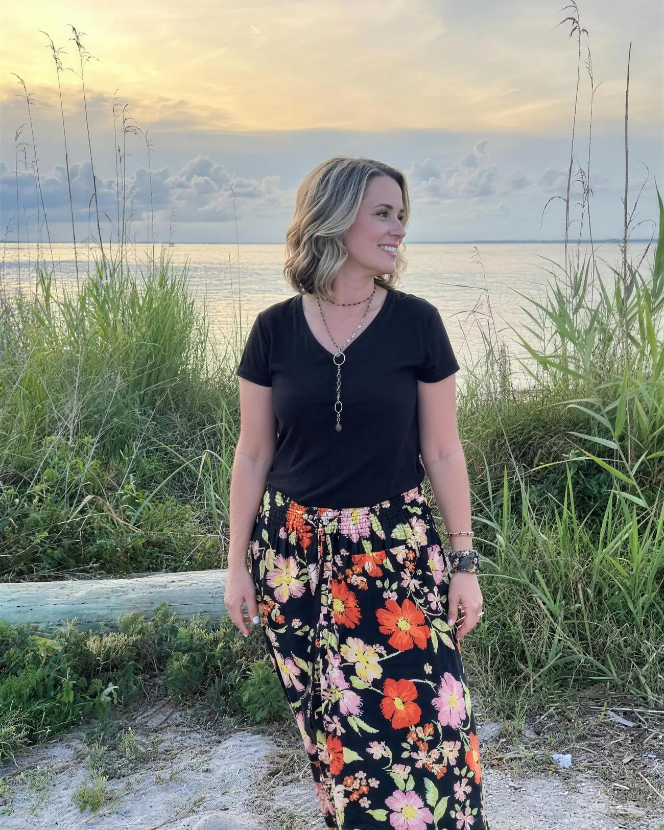 Jessica English standing on a shoreline at dusk.